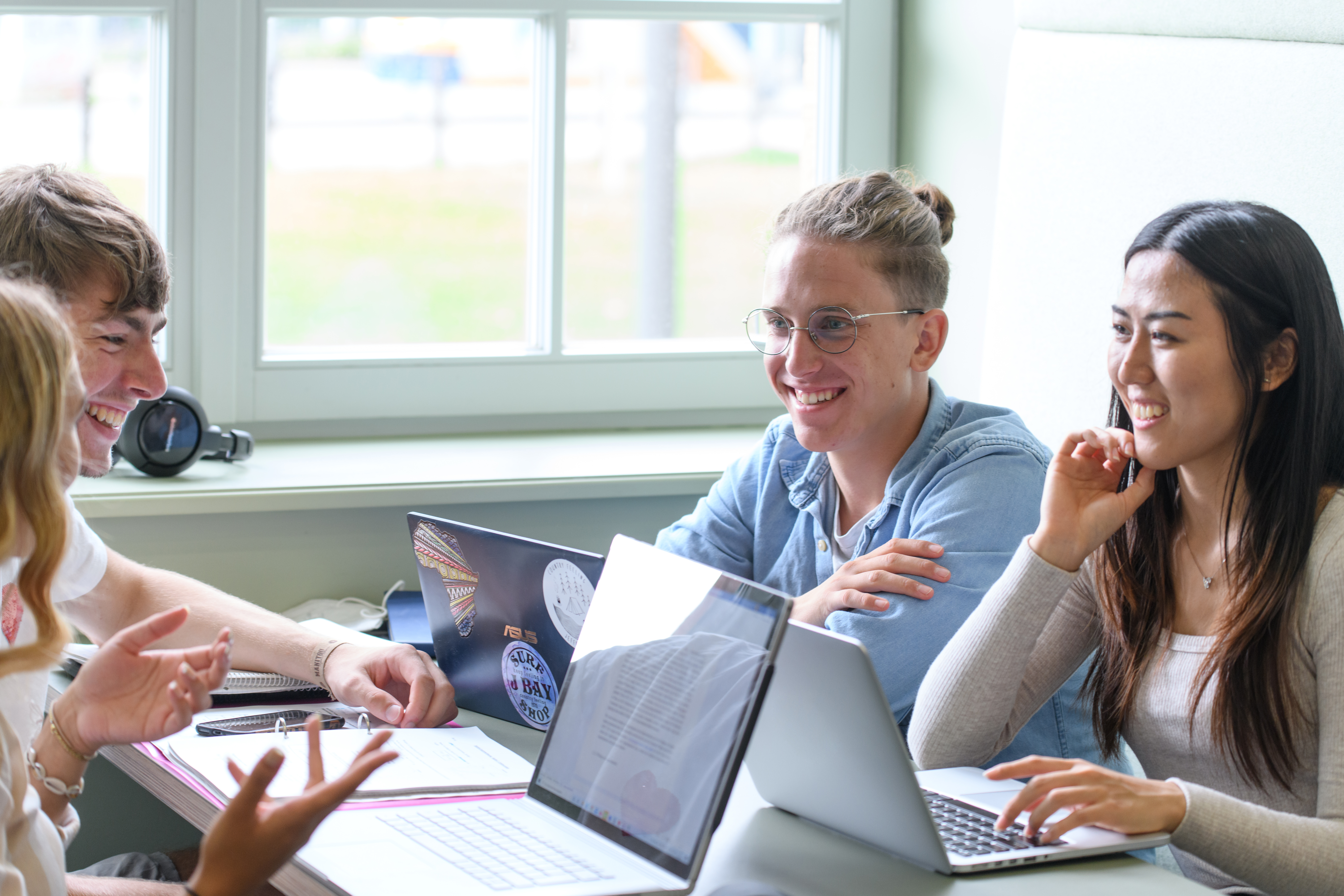 Students talking in a library co-working space