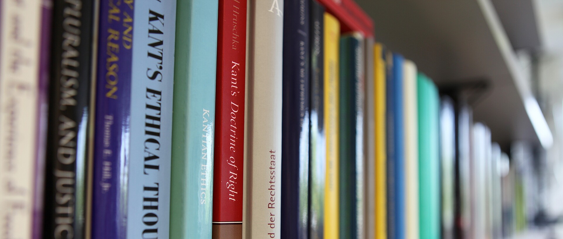 Books on a row of shelves. Some titles on the subject of Kant are clearly recognisable.